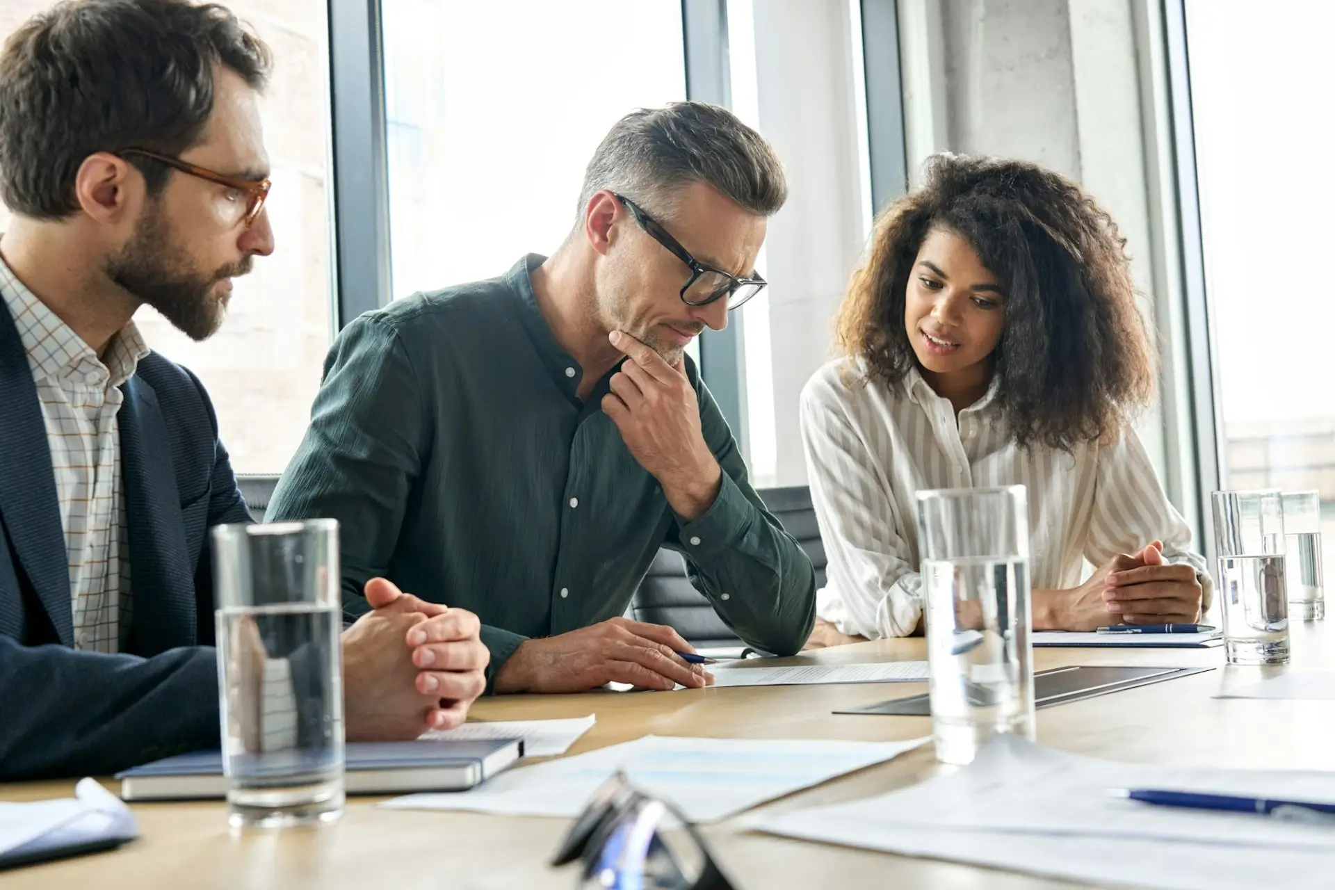 Personal injury lawyers in a strategy meeting discussing a client’s legal case and compensation options in a modern office setting.