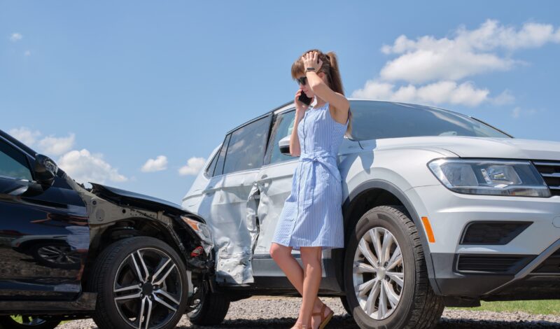 Person examining a car crash scene in Las Vegas while consulting with a car accident lawyer