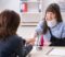 Car accident lawyer meeting with injured client wearing neck brace and arm sling during legal consultation
