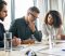 Personal injury lawyers in a strategy meeting discussing a client’s legal case and compensation options in a modern office setting.