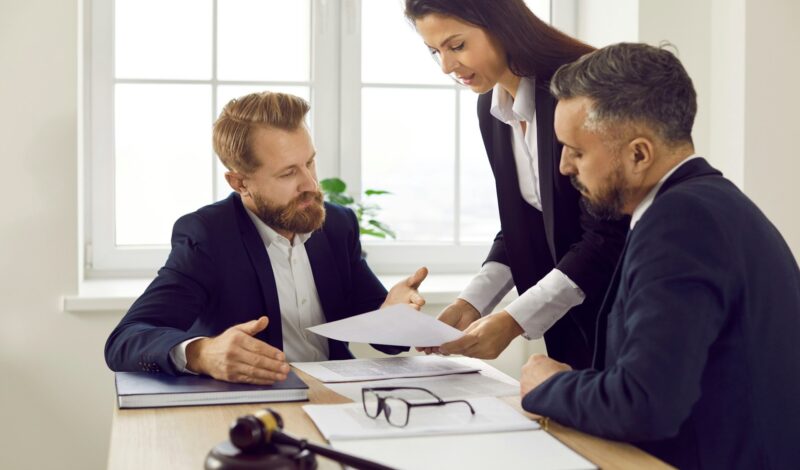 Auto accident attorney Las Vegas NV meeting with clients to review case documents in a law office