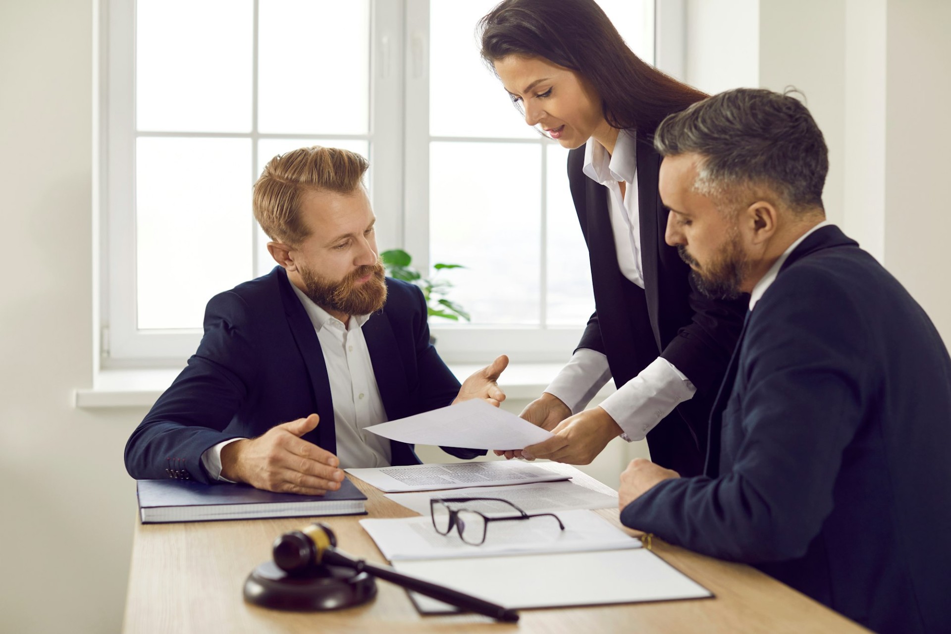 Auto accident attorney Las Vegas NV meeting with clients to review case documents in a law office