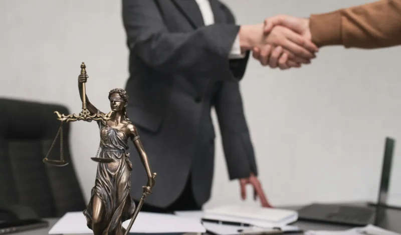 Personal injury attorney in Las Vegas shaking hands with client in Nevada law firm office
