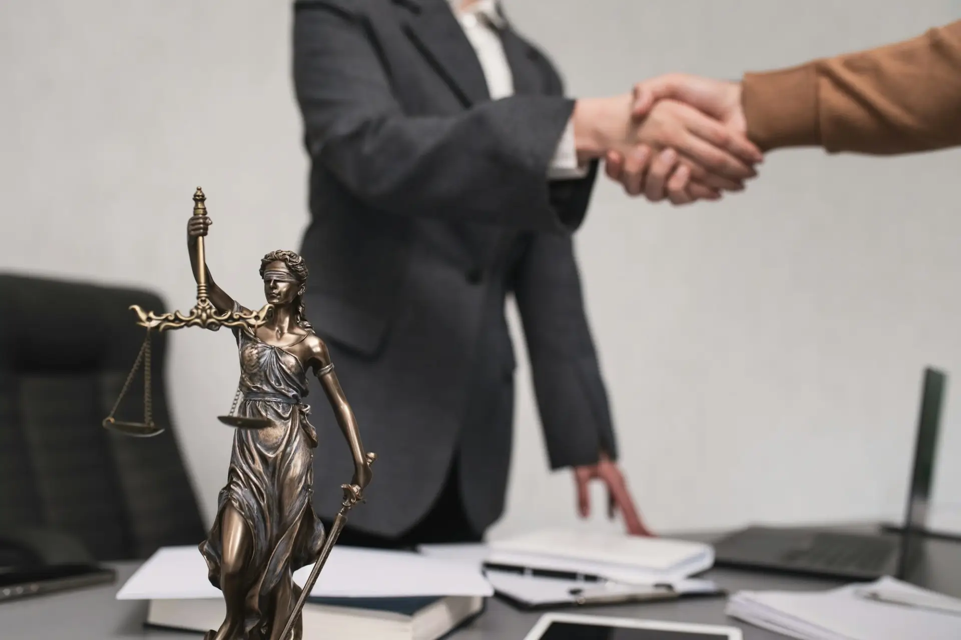 Personal injury attorney in Las Vegas shaking hands with client in Nevada law firm office