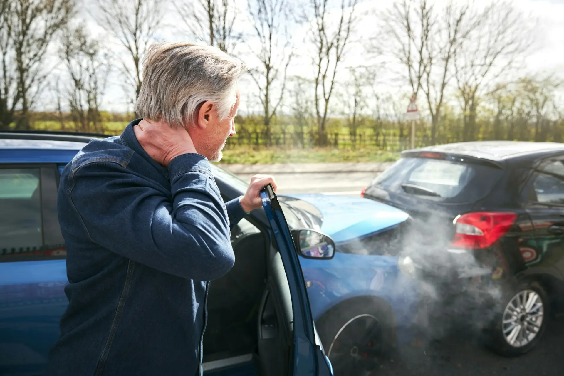 Driver holding neck after crash, signs of whiplash and injury that needs legal help from a car accident lawyer in Las Vegas.
