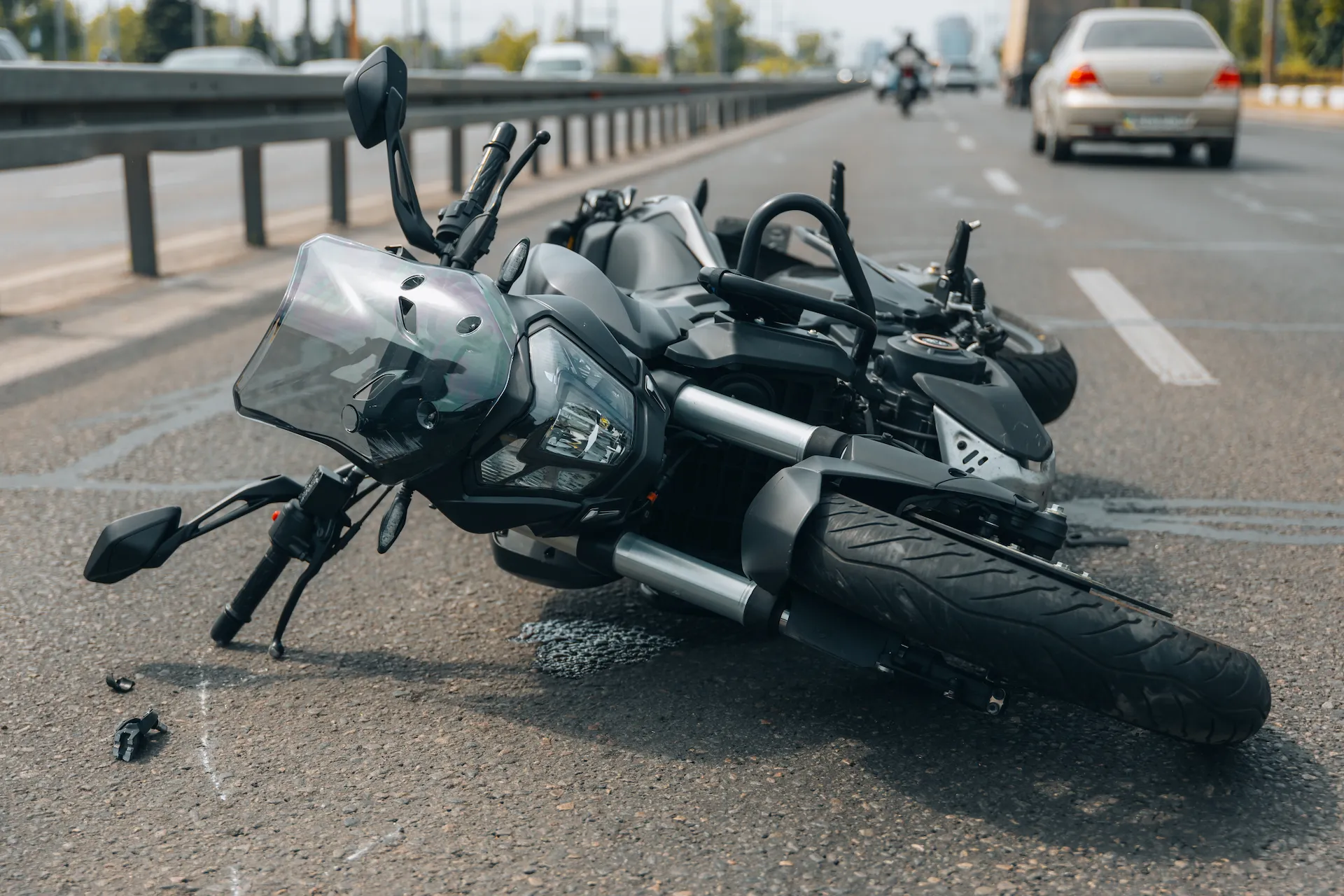 Motorcycle lying on the road after a crash, showing why contacting a motorcycle accident lawyer in Las Vegas is important after an accident.